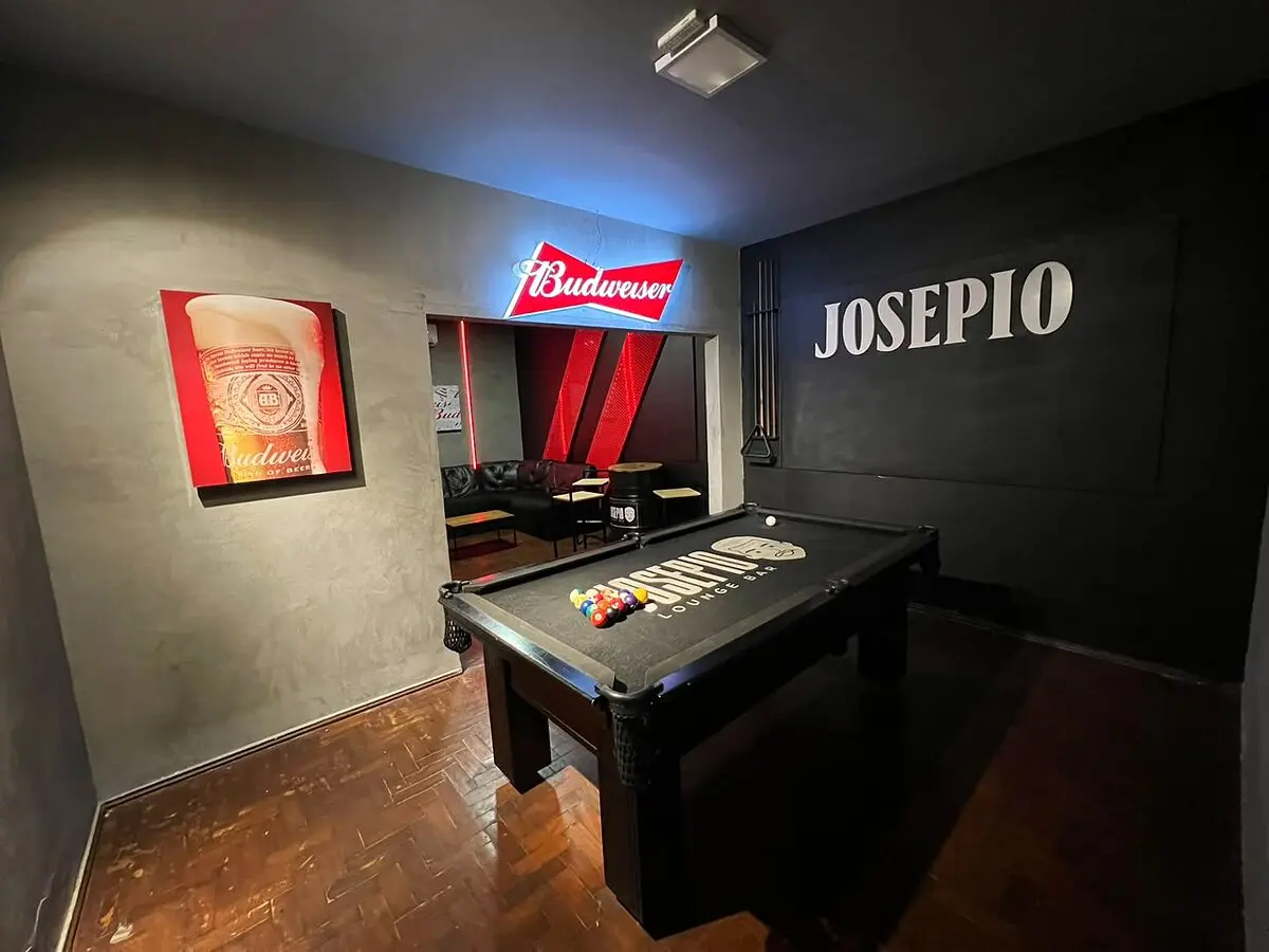 Sala VIP do Josepio com mesa de sinuca profissional, parede com o nome Josepio e neon da Budweiser